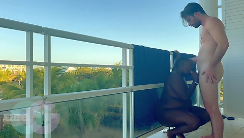 Horny black guy fucks a brunette in the resort balcony