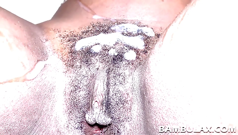 Ebony beauty is on her knees in front of the camera